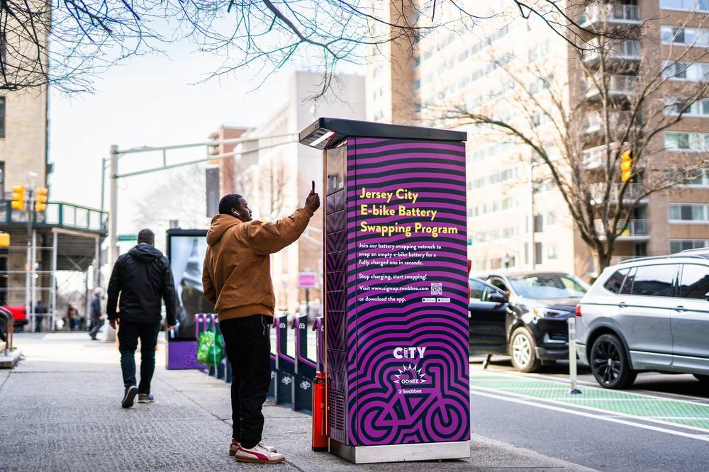 Rider swapping battery at Swobbee station in Jersey City